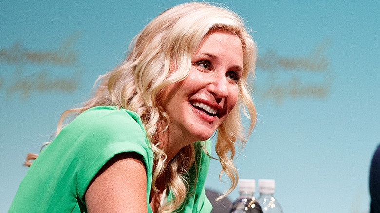 Jenny Marrs of HGTV's "Fixer to Fabulous" smiling onstage during an event.