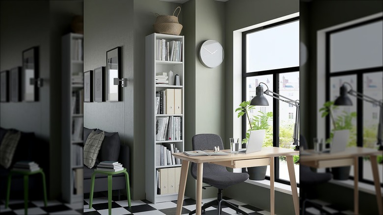 Narrow white BILLY Bookcase in an office space with wood table and checkered floor.