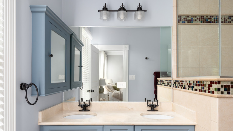 A classic bathroom with a blue painted medicine cabinet