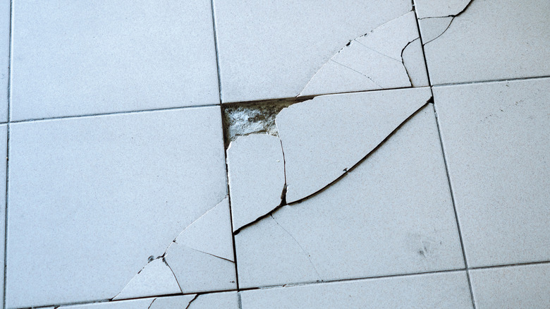 White cracked and chipped tile floors.
