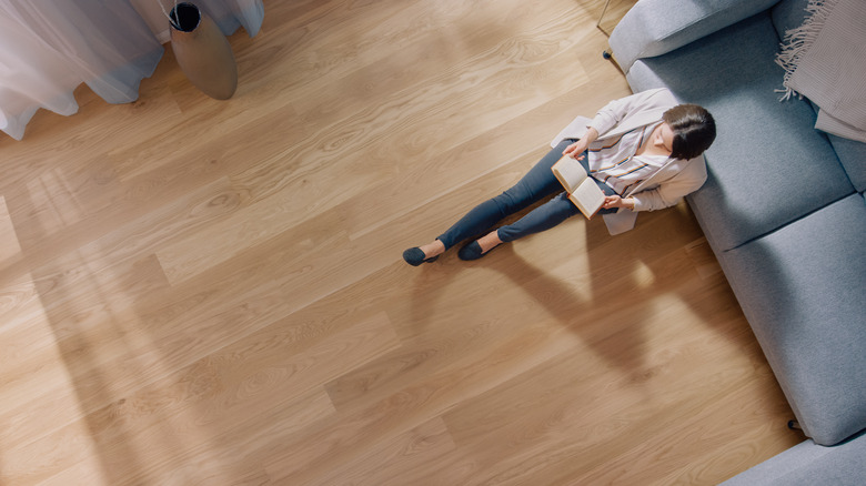 Person in room with wood floors