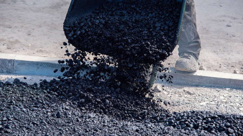 People installing a chip and seal driveway