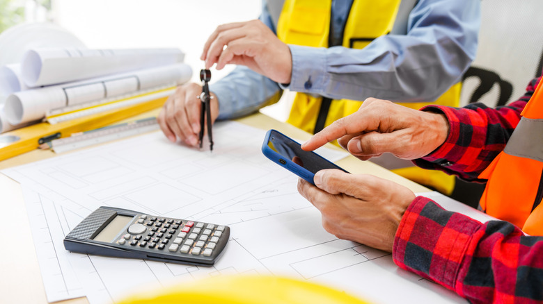 construction workers figuring out codes and permits