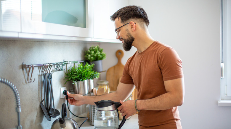 Man using outlet in kitchen