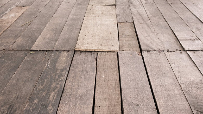Wooden plank floor with spaces in between