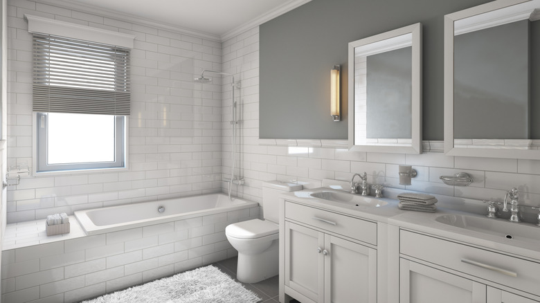 White subway tile in a mostly white bathroom with some gray accents