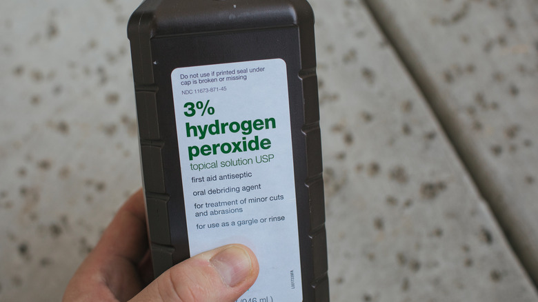 Person holding hydrogen peroxide