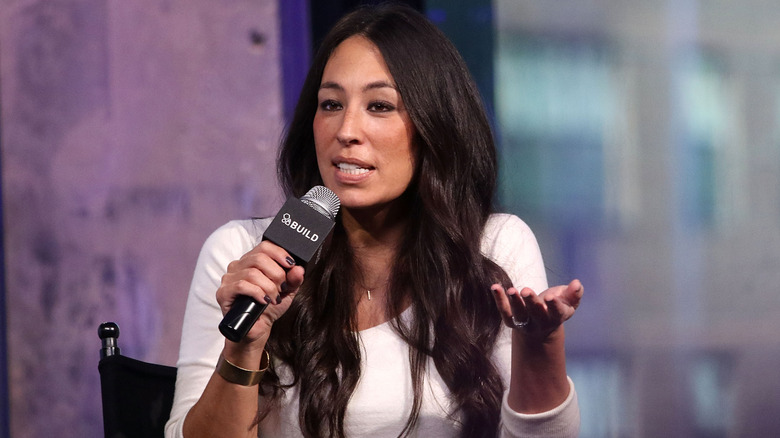 Joanna Gaines holding a microphone