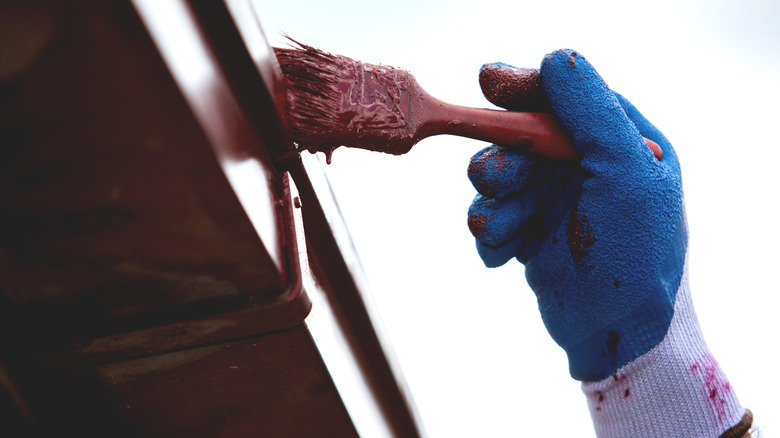 Person painting gutter
