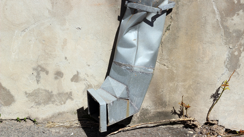 Dented metal downspout