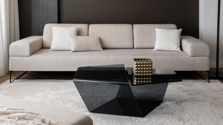 gray couch black glass coffee table