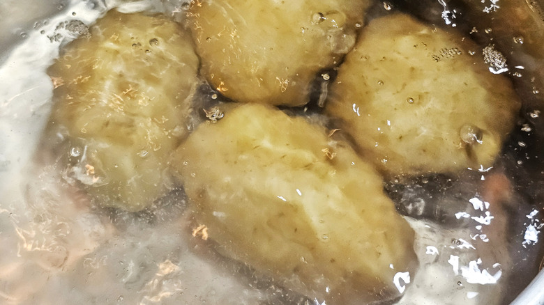 Potatoes boiling in a pot of water