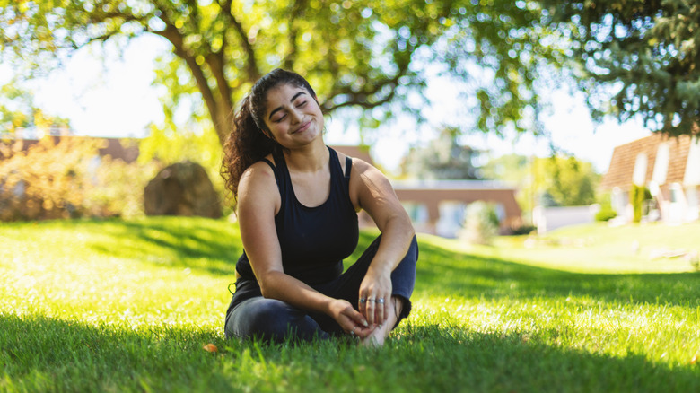 woman sitting on ground in shade
