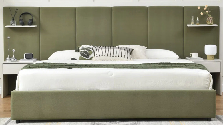 Green wall-to-wall headboard in bedroom.