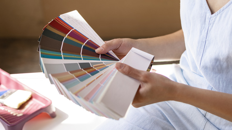 Person looking at paint chip colors