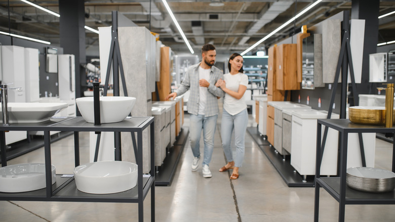 Couple shopping for bathroom features at a show room