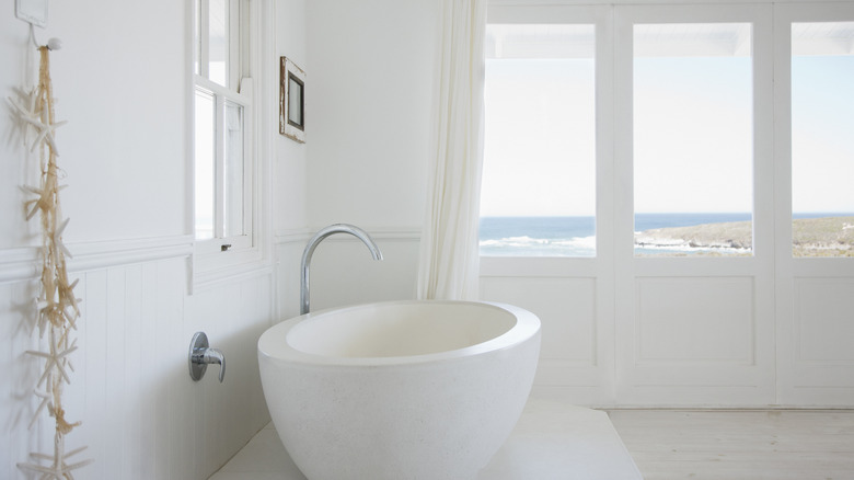 All-white bathroom with windows