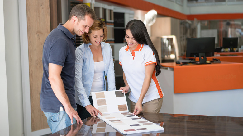 People looking at hardwood floor samples