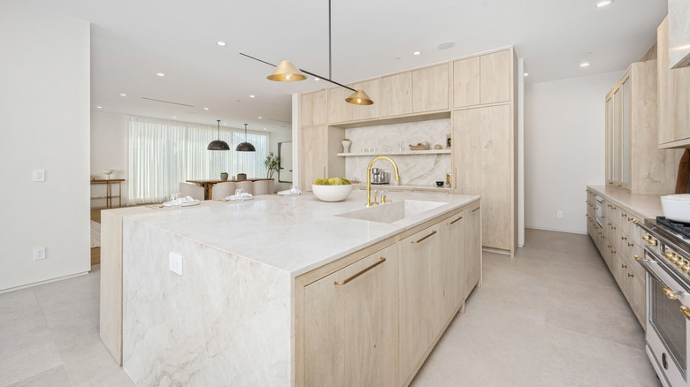 modern and minimal light-colored kitchen with lots of natural stone