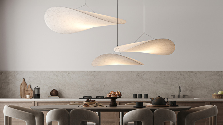 Three-piece sculptural pendant light over table