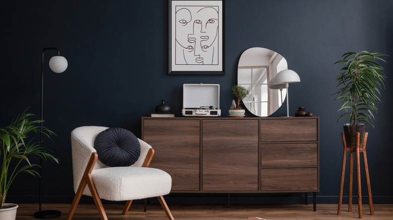 Black wall with wooden furniture