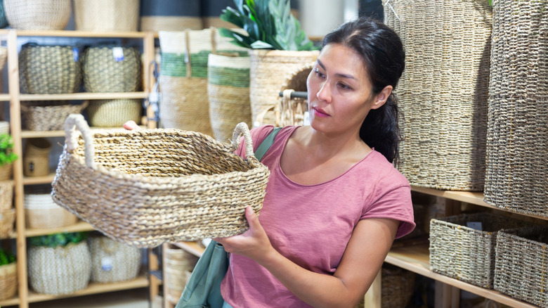 Woman shopping for a woven basket