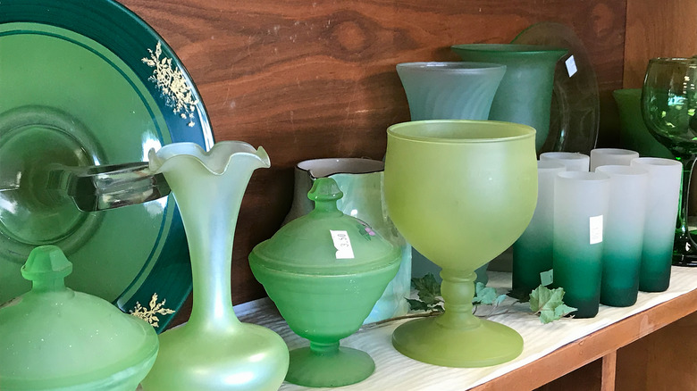 Green vintage glassware in a thrift store