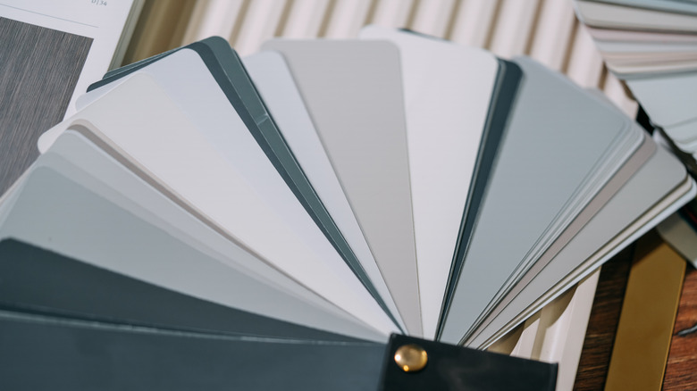 Paint swatch featuring grays, greens, and blues.