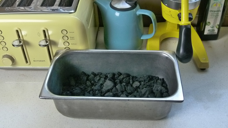 Pan of charcoal on counter 