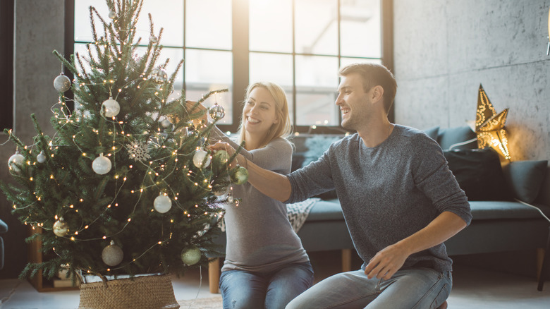 couple decorating tree