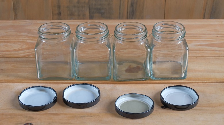 jars lined up on wood surface