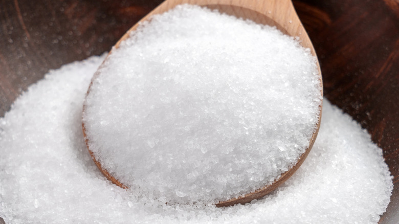 Salt on spoon in bowl