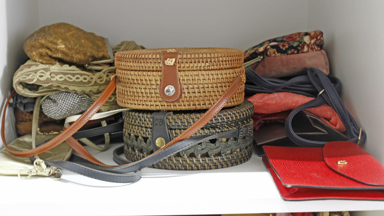 purses stacked on closet shelf