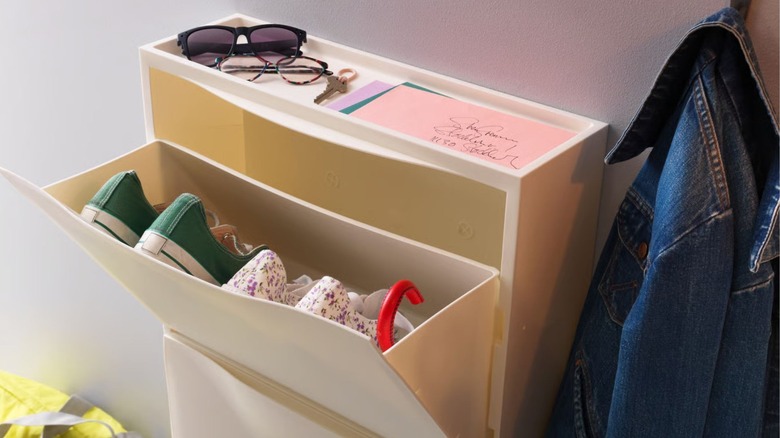 IKEA TRONES cabinet with the top bin open to reveal shoes