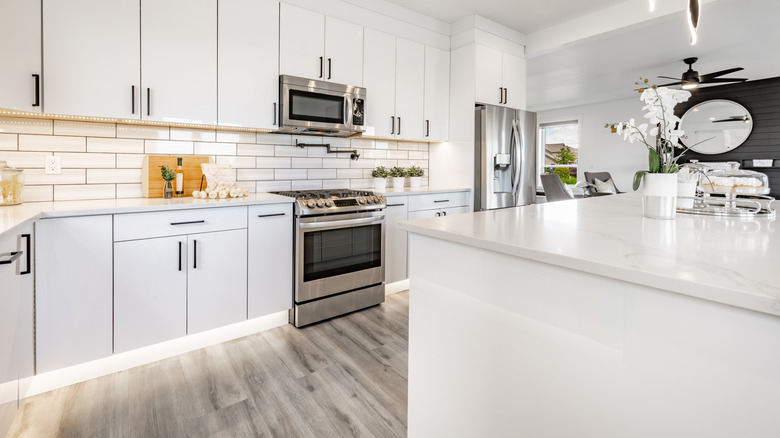 White and gray kitchen with vinyl flooring