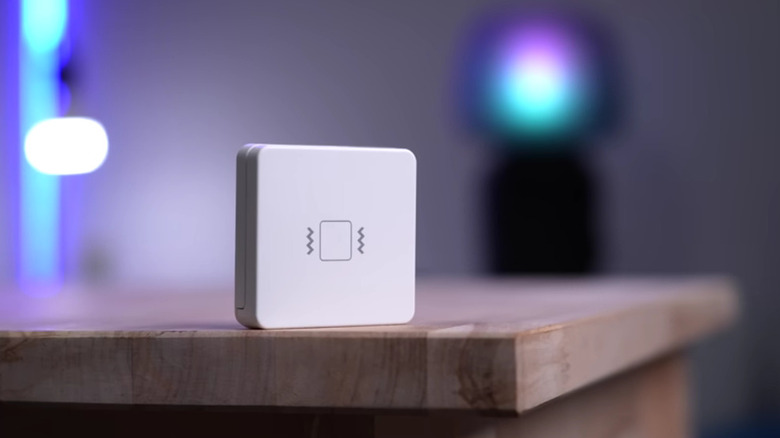 A rectangular shaped vibration sensor on a table