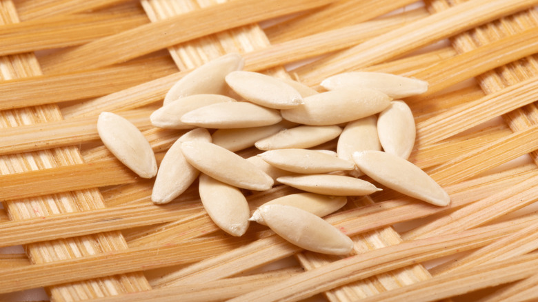 Cucumber seeds in a pile on a woven background