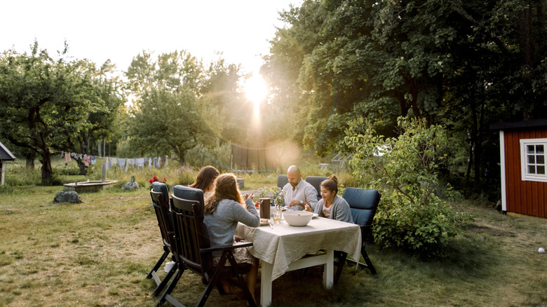 family eating outdoors under the sun