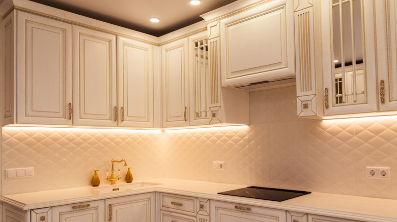 White kitchen cabinets that need a little sprucing up with a budget-friendly DIY decor hack