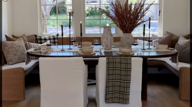 raised banquette seating with wicker benches and wood table
