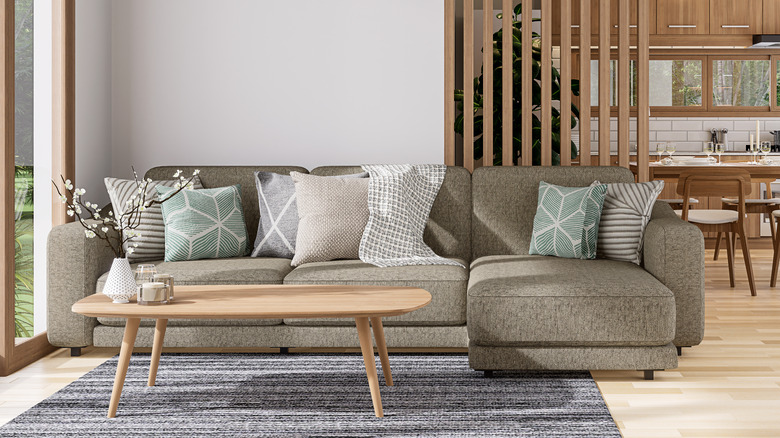 Open space living room and kitchen with large couch.