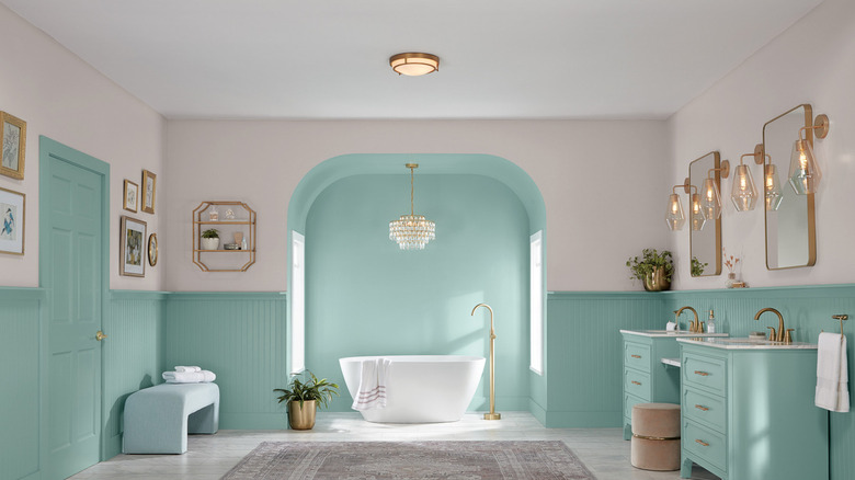 A bathroom with Renew Blue by Valspar on the bathroom cabinets and bottom walls