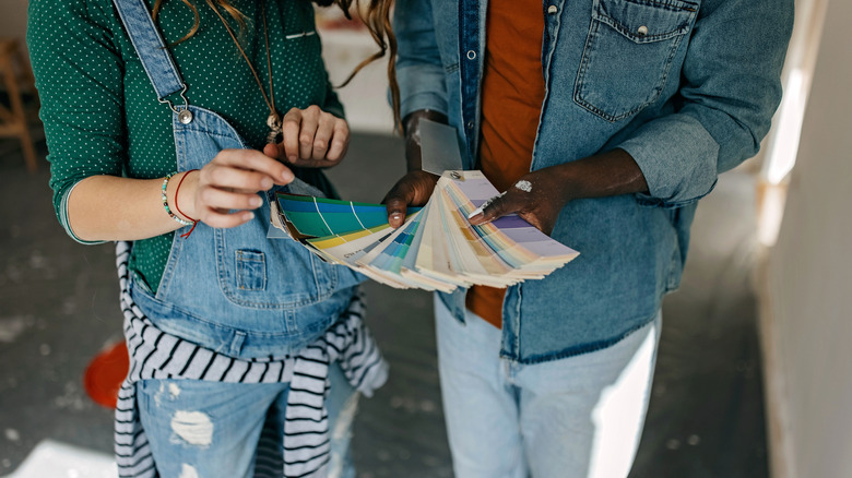 A couple looks at different paint samples