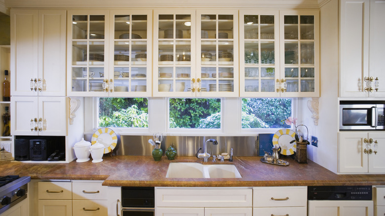 Stylish kitchen with glass front cabinets
