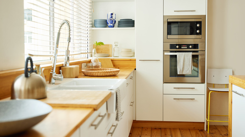 A clean, modern-looking kitchen in white and wood