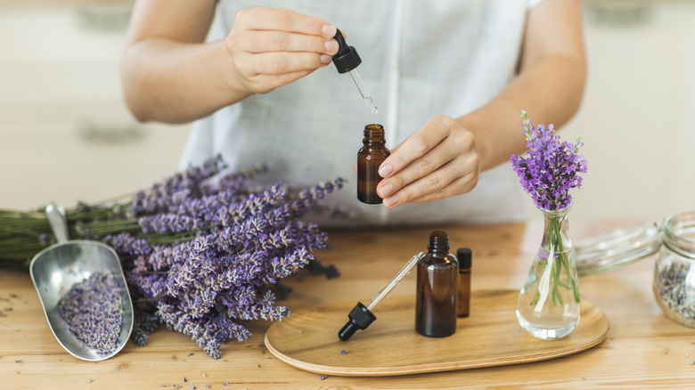 A woman making essential oils with lavender