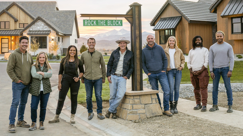 Cast of Rock the Block smiling in front of houses
