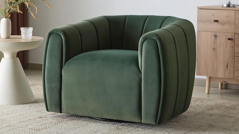A green velvet tufted arm chair.