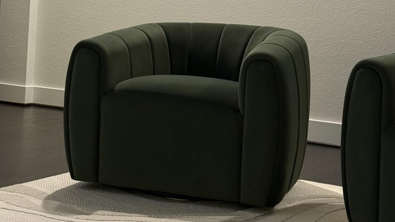A close up on a green velvet Art Deco chair.
