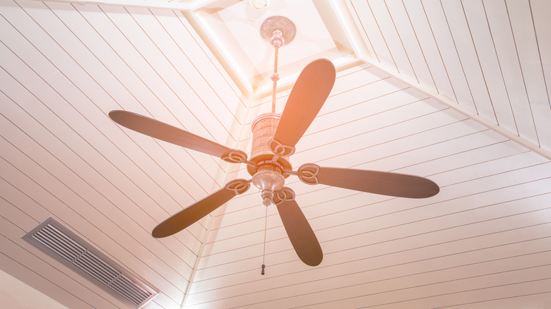 fan hanging from wood ceiling